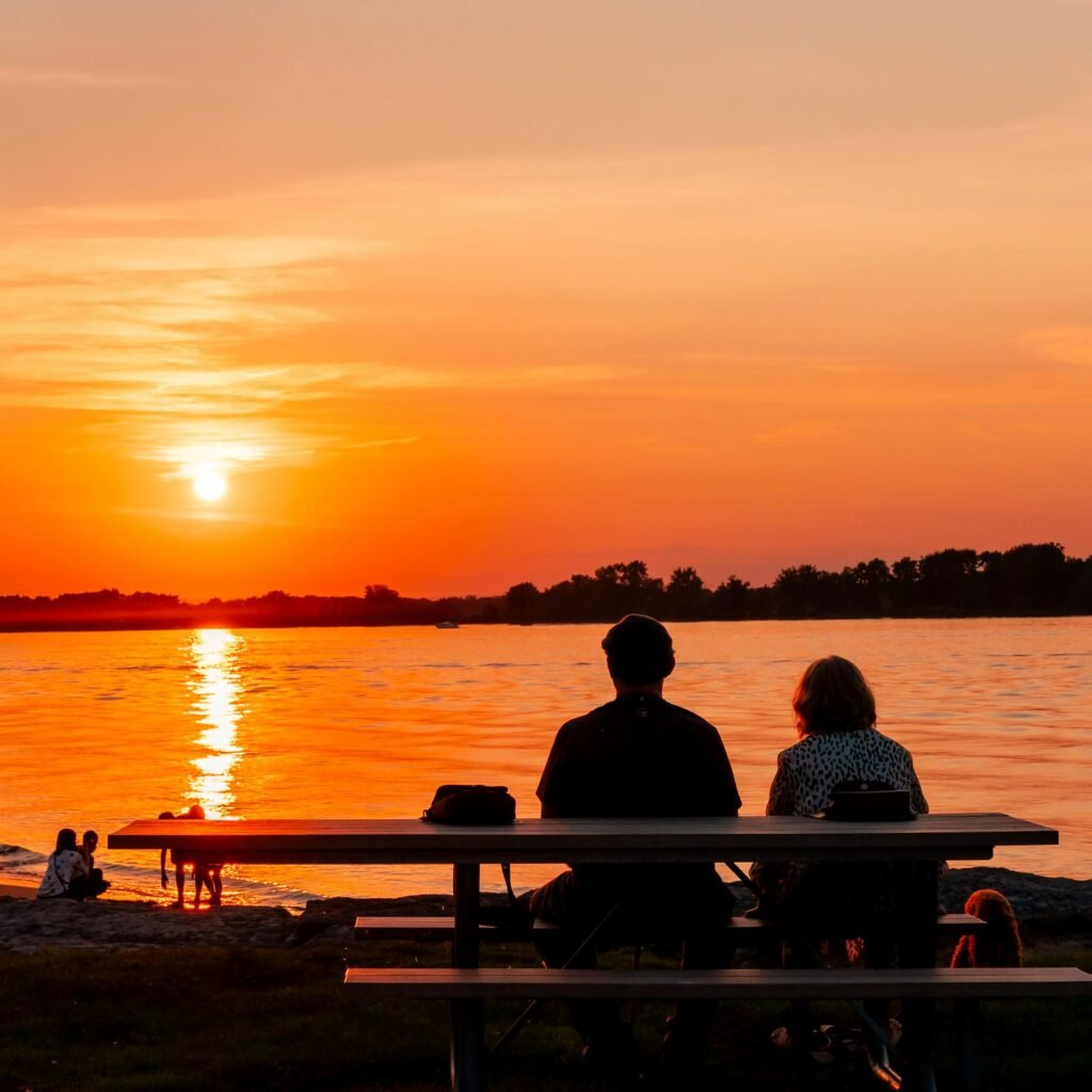 Couple enjoying a beautiful sunset by the Ottawa River in Canada.